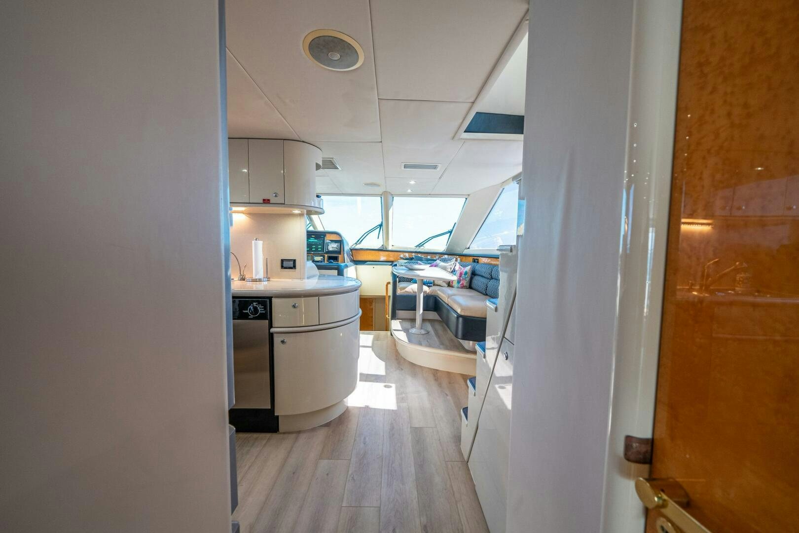 a kitchen with a white refrigerator aboard PRESTIGE WORLDWIDE Yacht for Sale