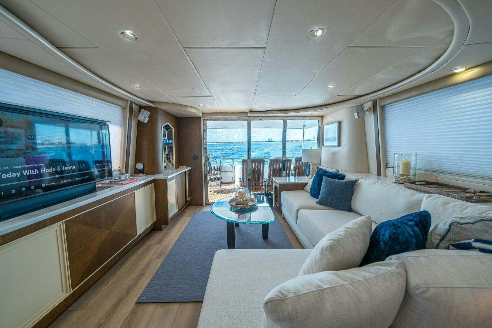 a living room with a large television aboard PRESTIGE WORLDWIDE Yacht for Sale
