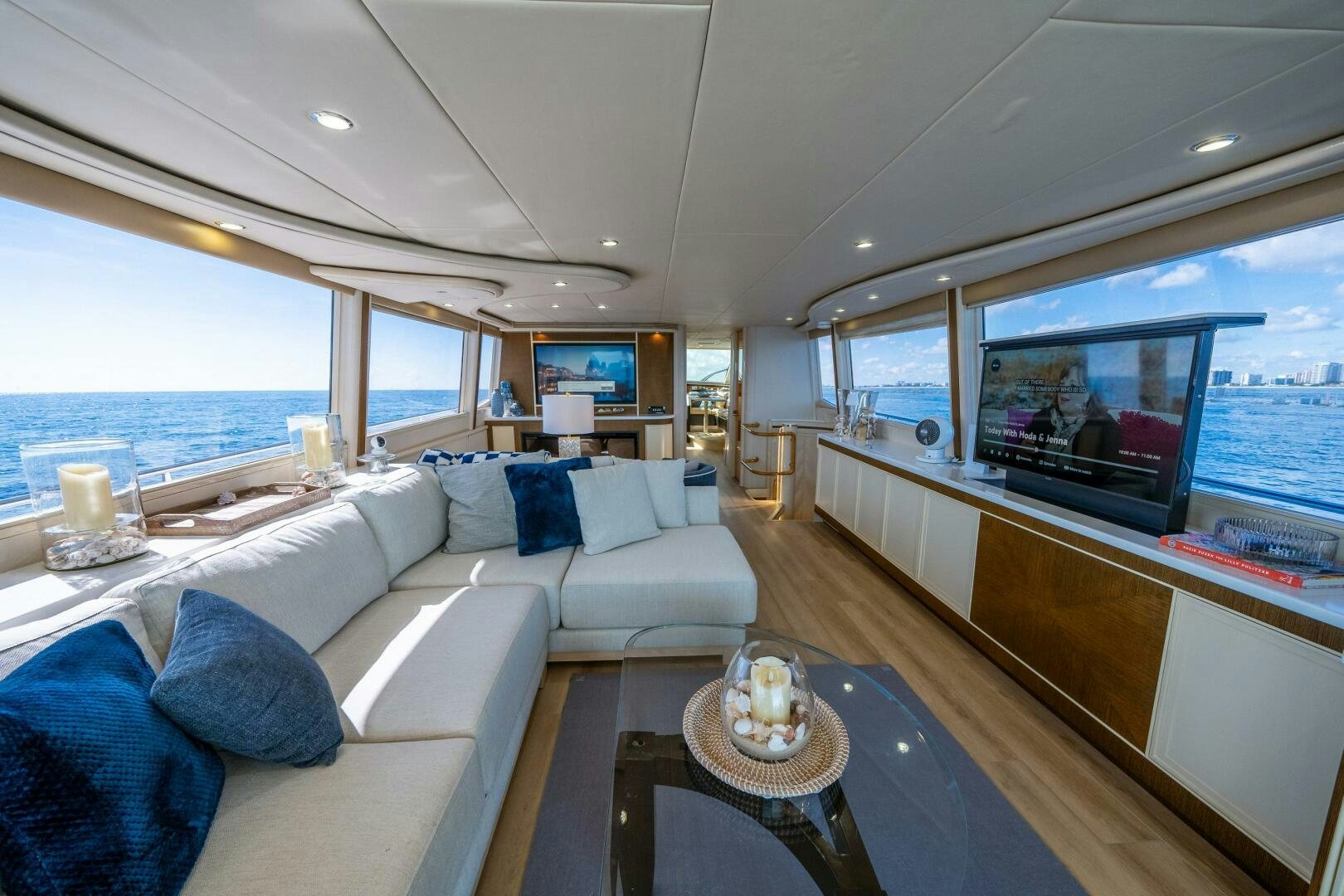 a living room with a large television aboard PRESTIGE WORLDWIDE Yacht for Sale