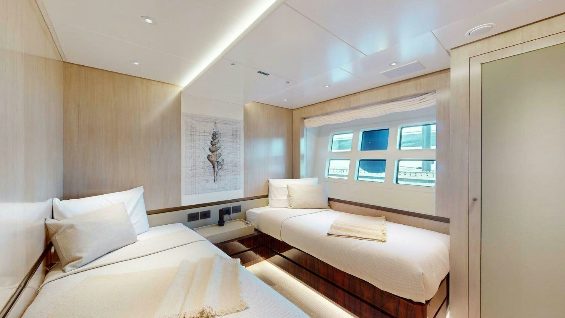 a room with two beds aboard OCEANIC 140 Yacht for Sale