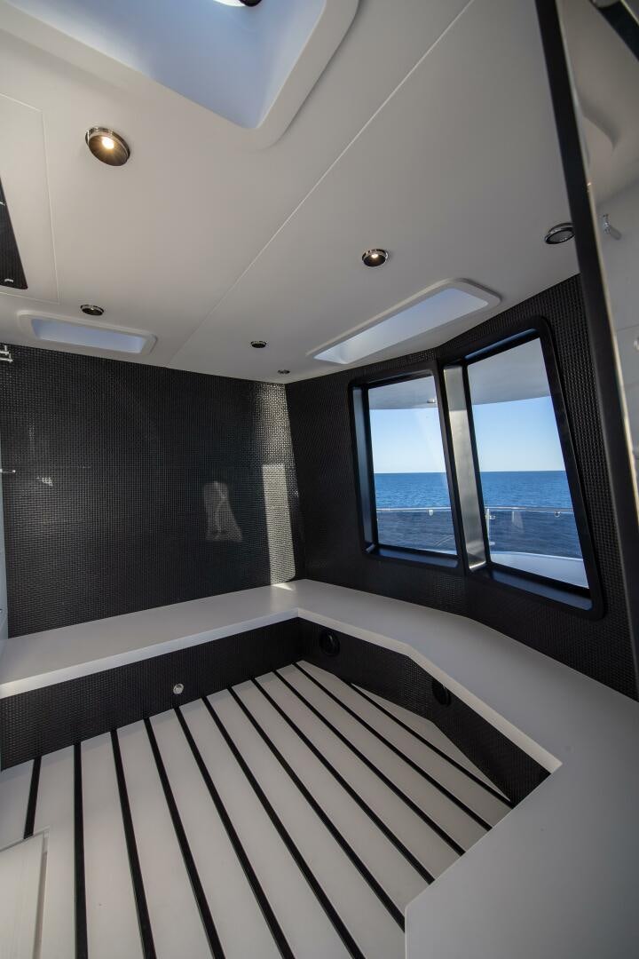 a room with a window and a view of the water aboard OCEANIC 140 Yacht for Sale