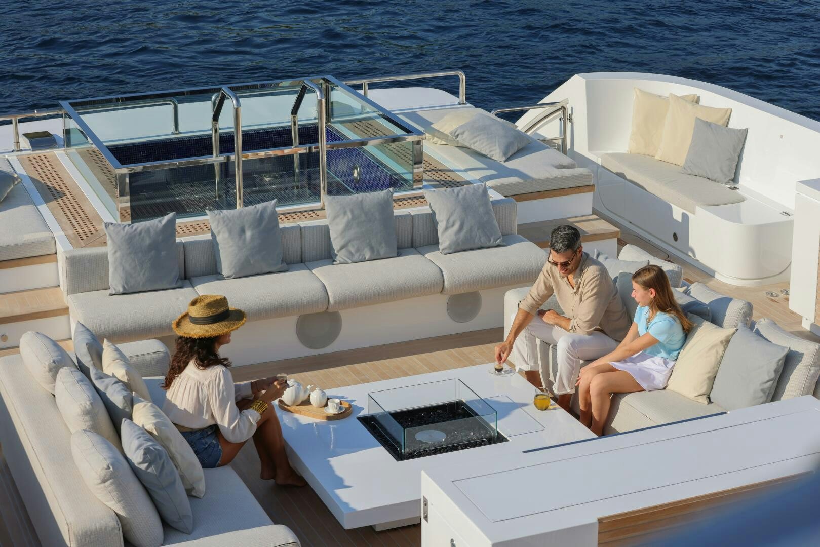 a group of people sitting on a boat aboard OCEANIC 140 Yacht for Sale