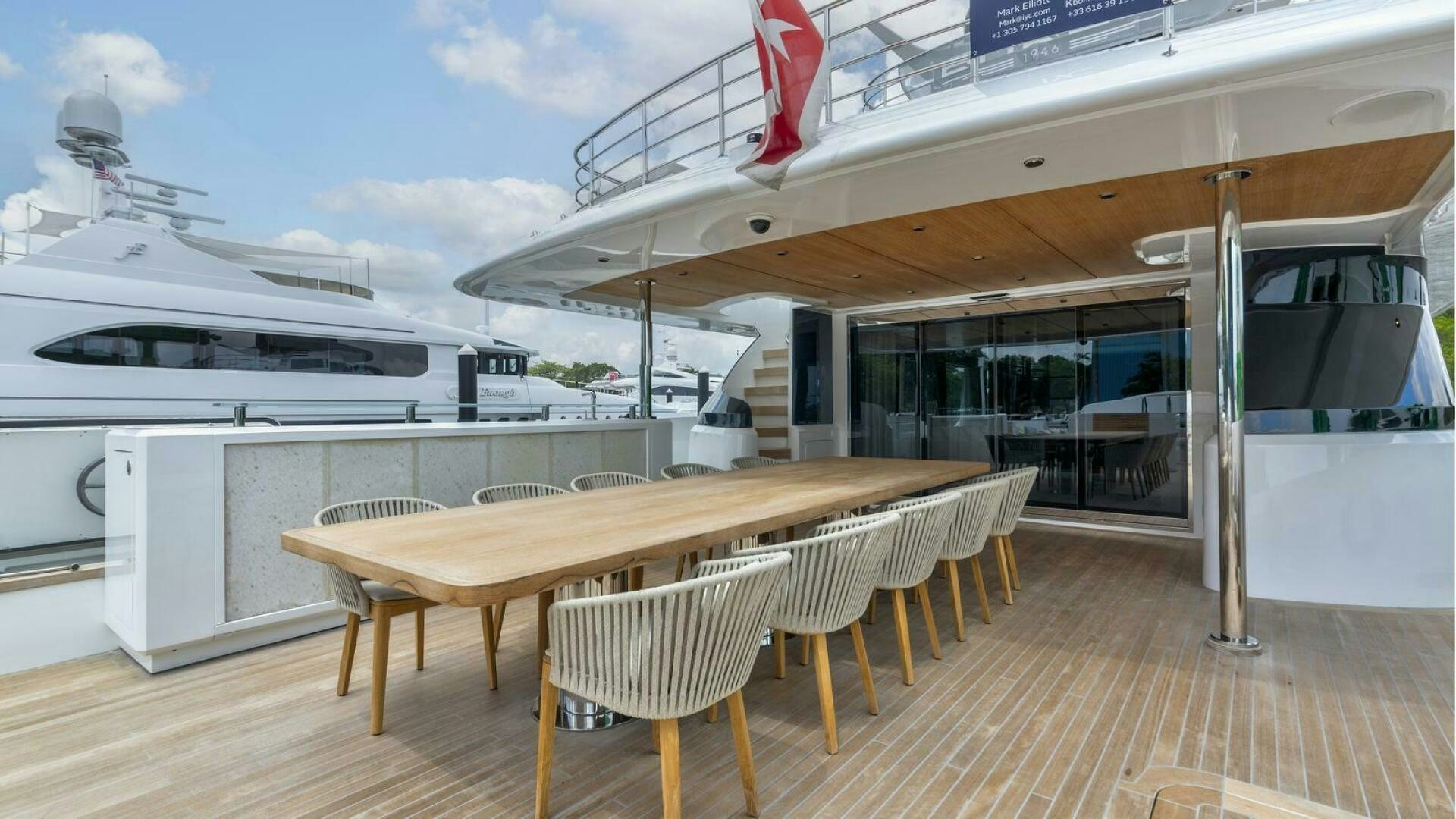 a table and chairs in a room aboard OCEANIC 140 Yacht for Sale