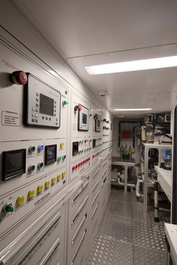 a room with white cabinets and electronic equipment aboard OCEANIC 140 Yacht for Sale