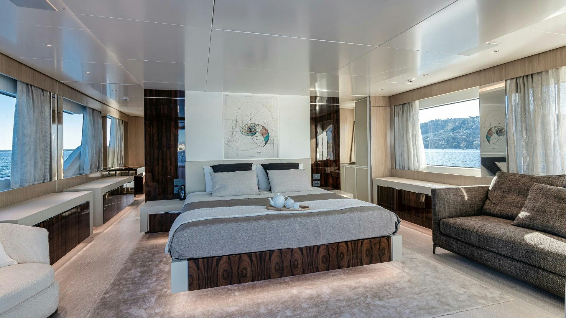 a large bedroom with a bed and a couch aboard OCEANIC 140 Yacht for Sale