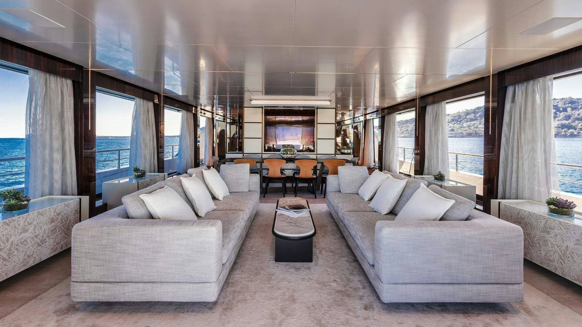 a living room with a couch and a table aboard OCEANIC 140 Yacht for Sale