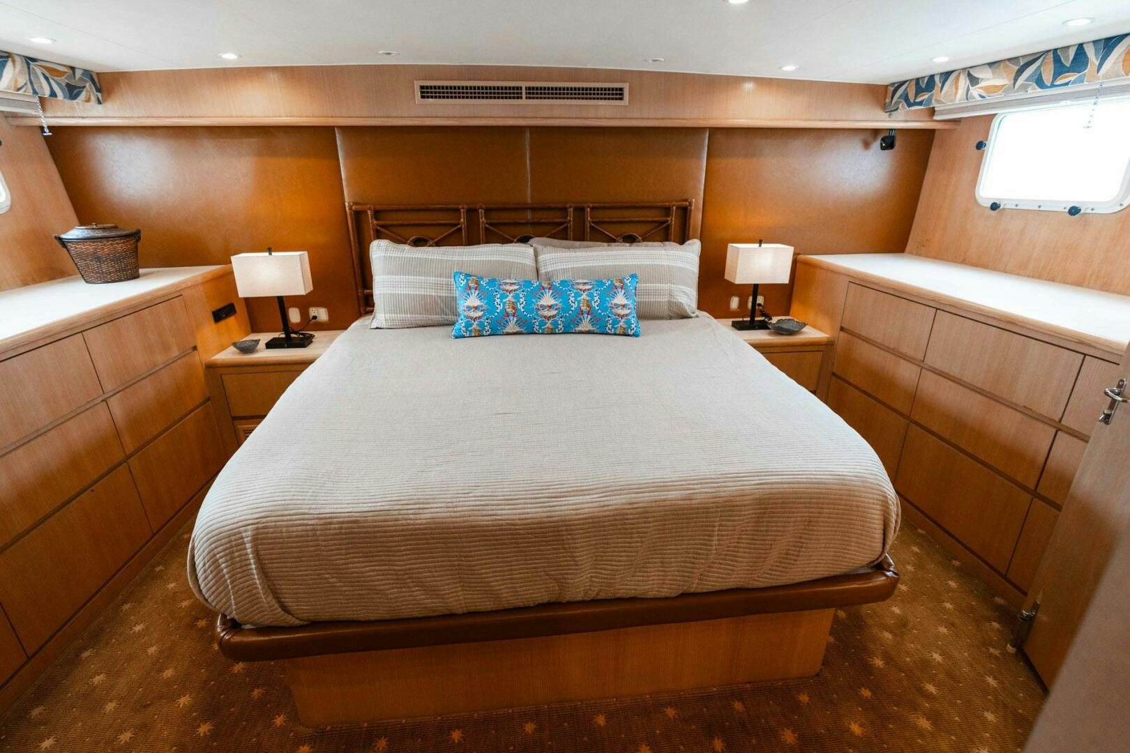 a bed with a white comforter aboard KRAKEN Yacht for Sale