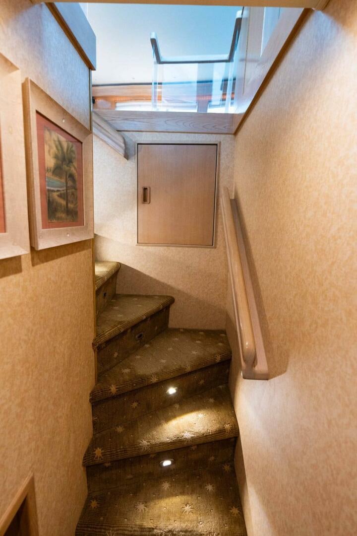 a staircase with a wood railing aboard KRAKEN Yacht for Sale