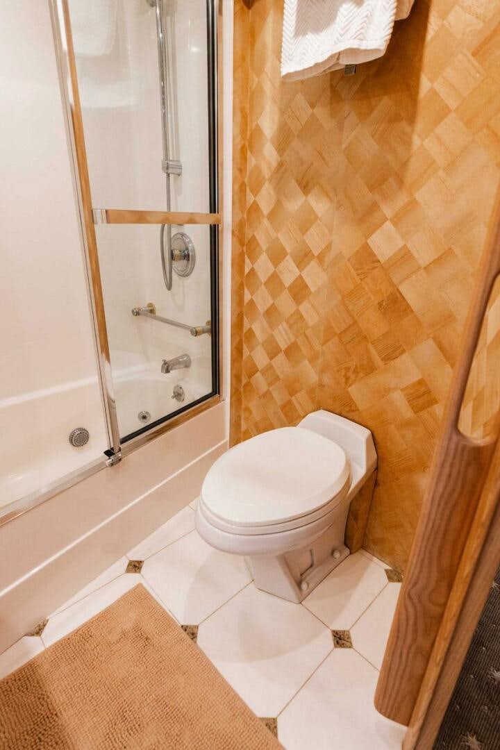 a bathroom with a toilet and a shower aboard KRAKEN Yacht for Sale