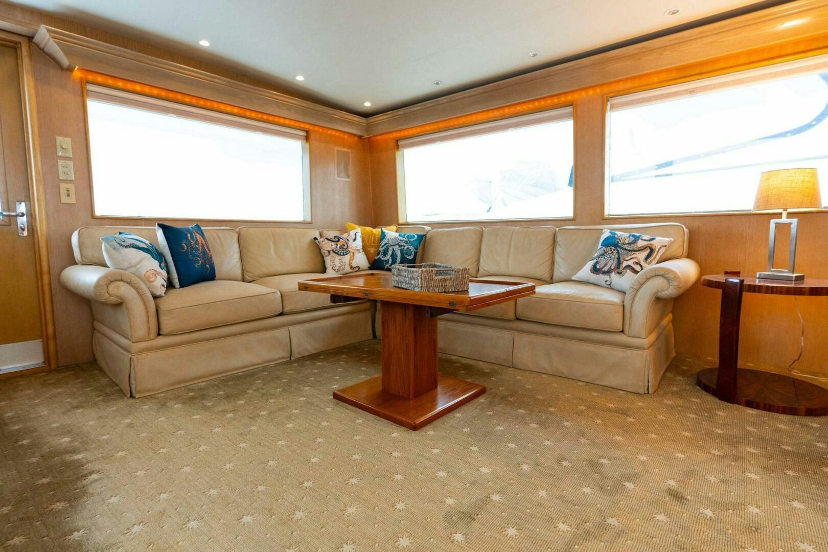 a living room with a couch and a coffee table aboard KRAKEN Yacht for Sale