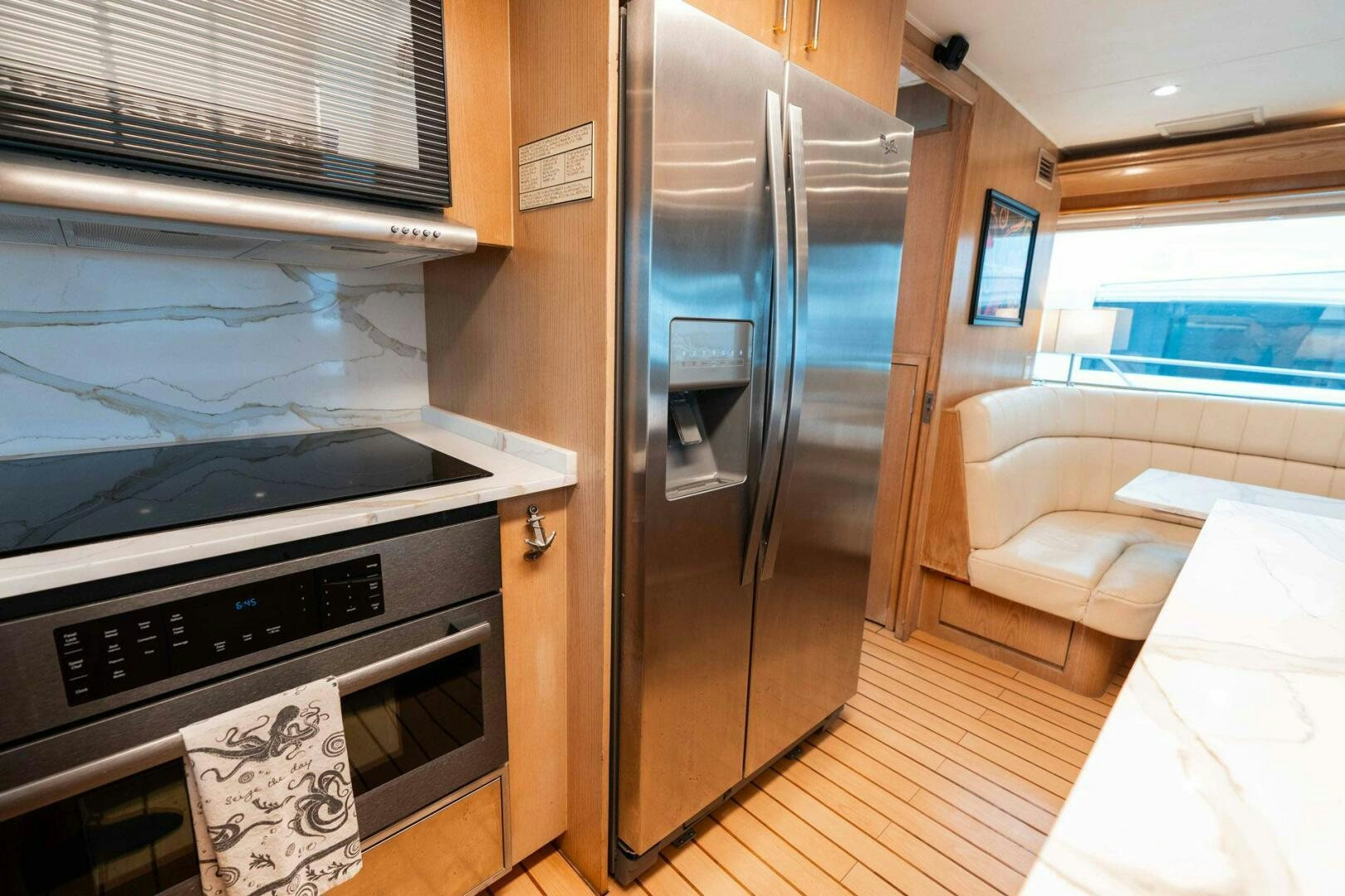 a kitchen with a refrigerator and oven aboard KRAKEN Yacht for Sale