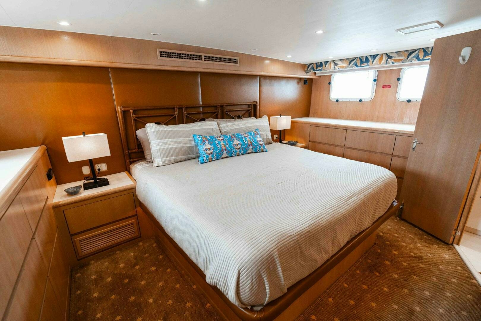 a bedroom with a bed and a desk aboard KRAKEN Yacht for Sale
