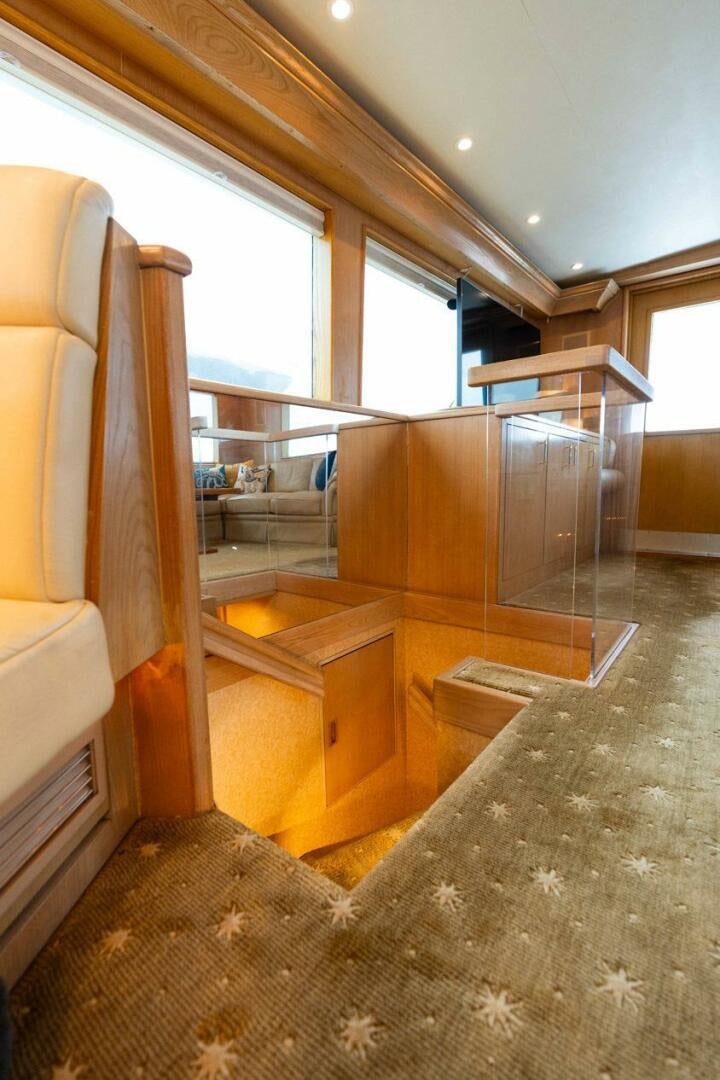 a room with a wood floor and a wood cabinet and a rug aboard KRAKEN Yacht for Sale
