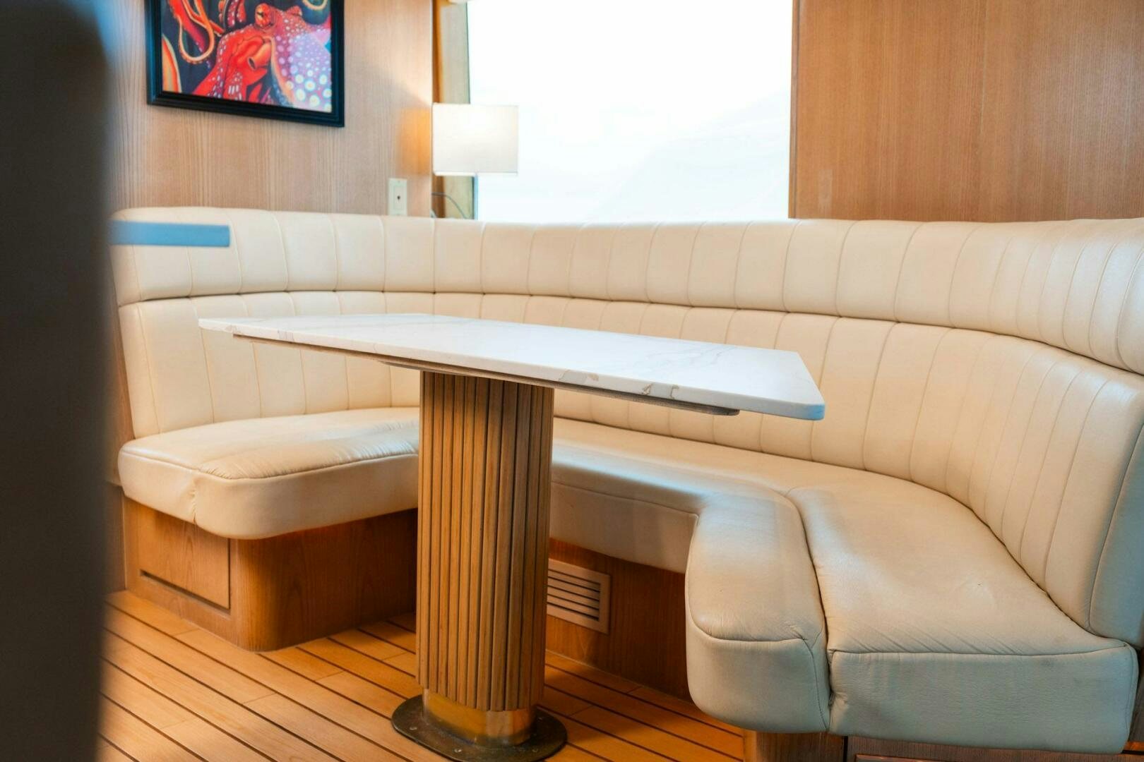 a couch with a table in front of it aboard KRAKEN Yacht for Sale