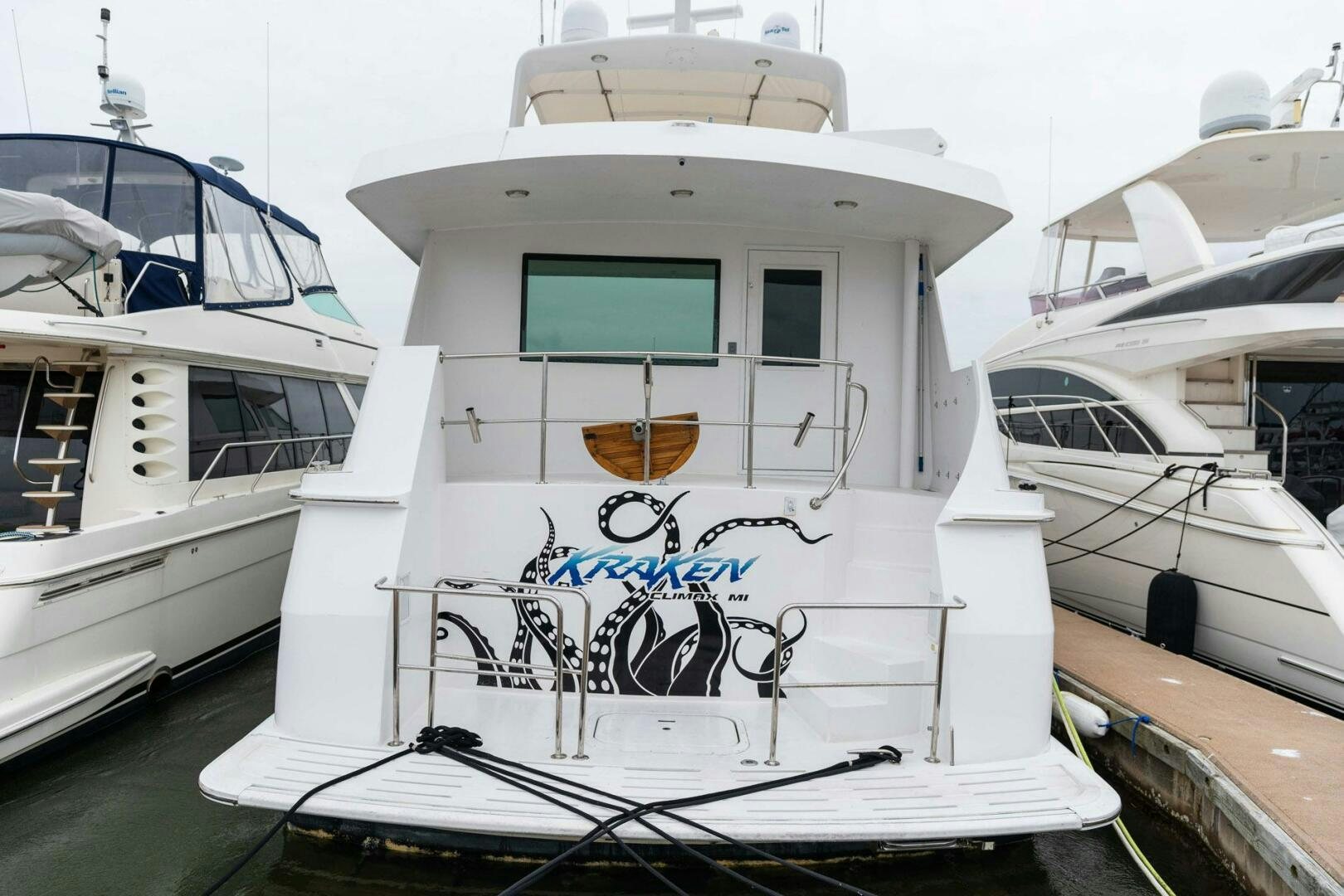 a white boat with graffiti on it aboard KRAKEN Yacht for Sale