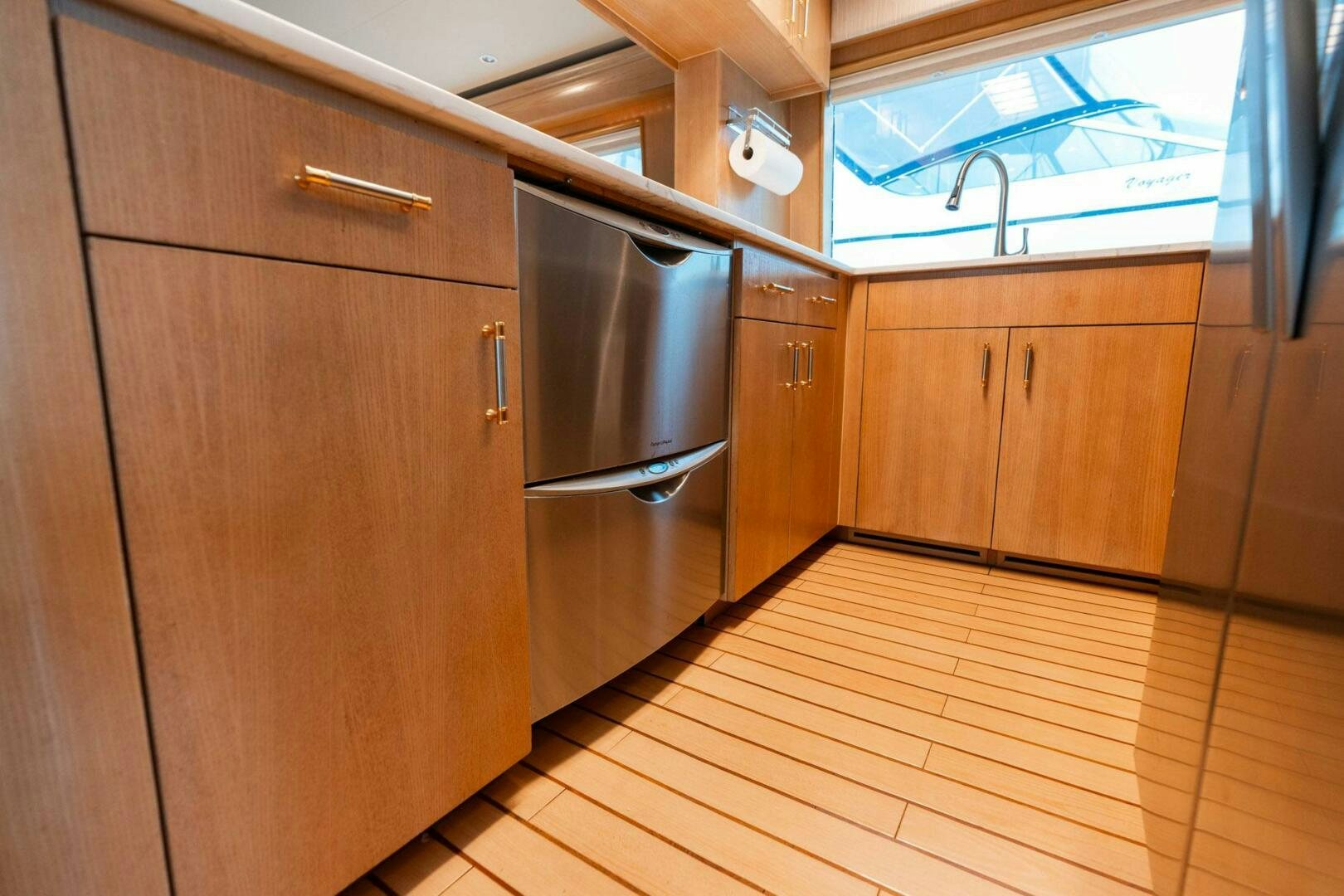 a kitchen with wooden cabinets aboard KRAKEN Yacht for Sale