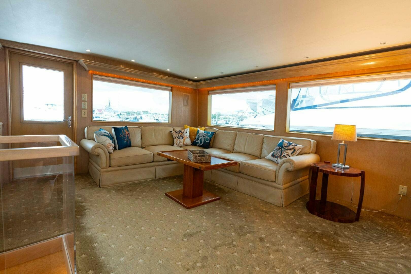 a living room with a couch and a coffee table aboard KRAKEN Yacht for Sale