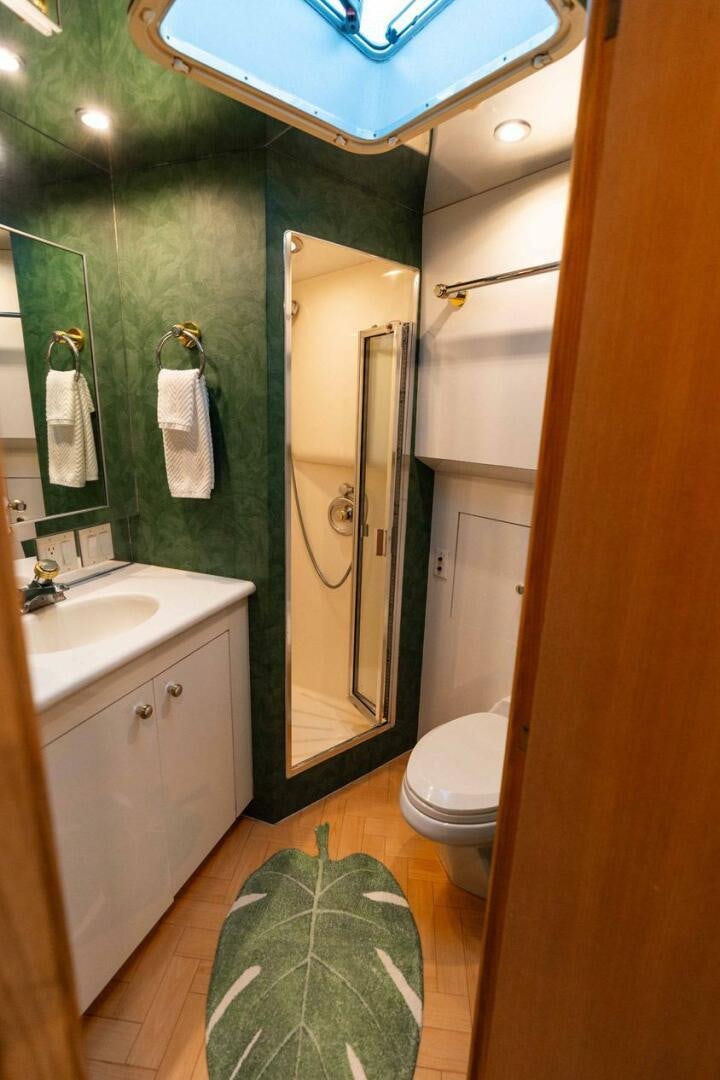 a bathroom with a shower and toilet aboard KRAKEN Yacht for Sale