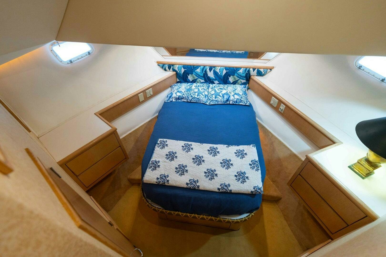 a blue and white striped bed aboard KRAKEN Yacht for Sale