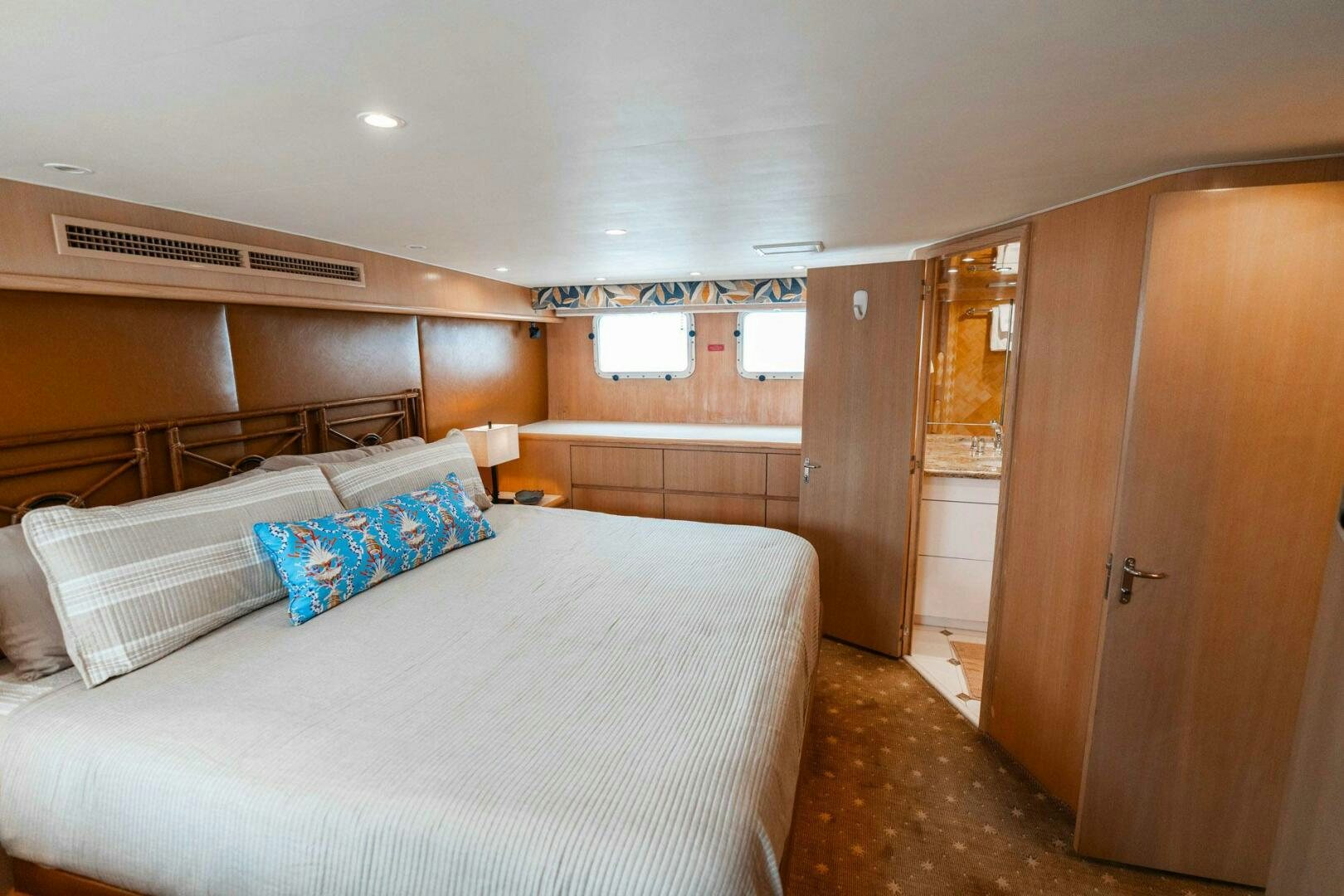 a bedroom with a bed and a closet aboard KRAKEN Yacht for Sale