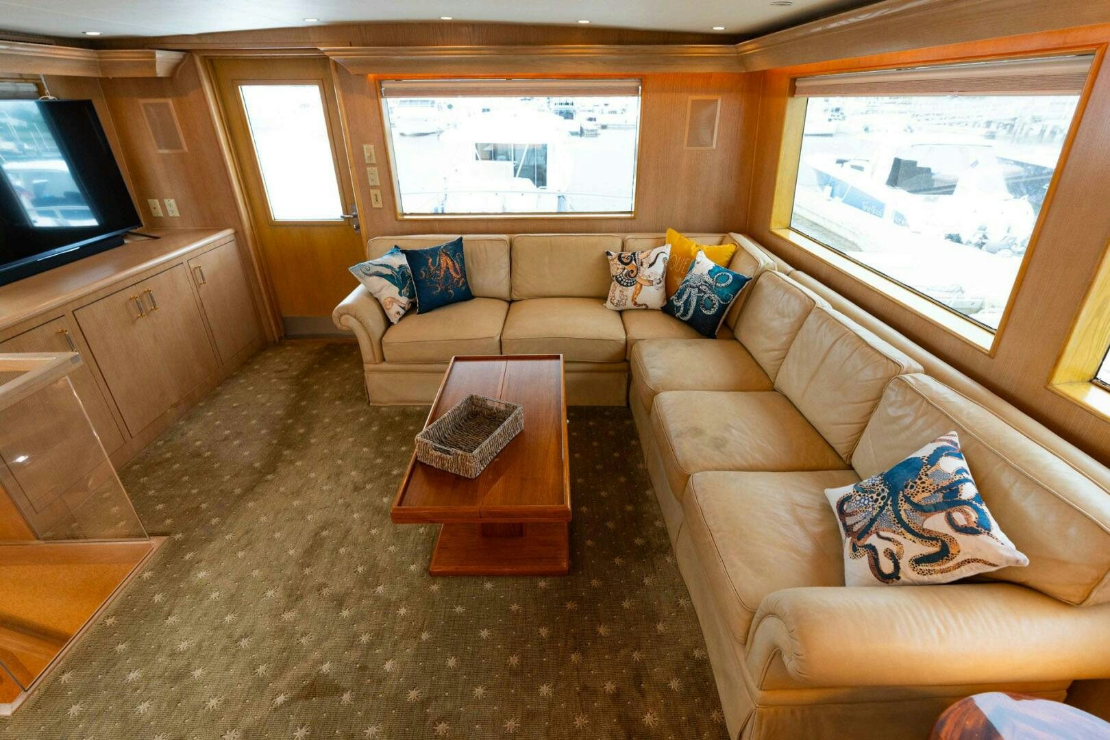 a living room with a couch and a tv aboard KRAKEN Yacht for Sale