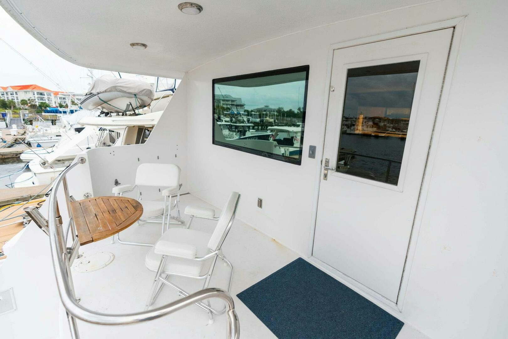 a room with a table chairs and a window aboard KRAKEN Yacht for Sale