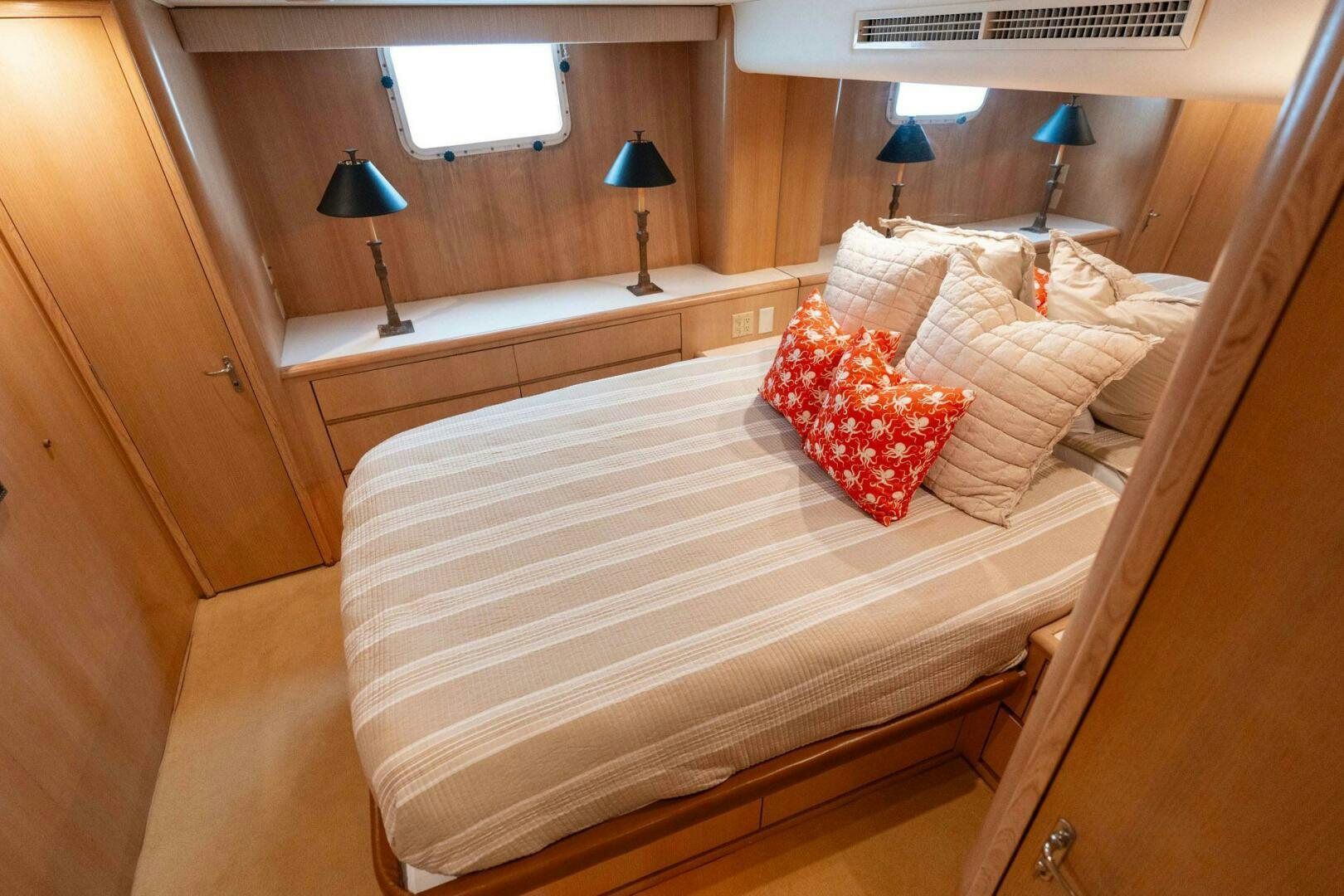 a room with a bed and a lamp aboard KRAKEN Yacht for Sale