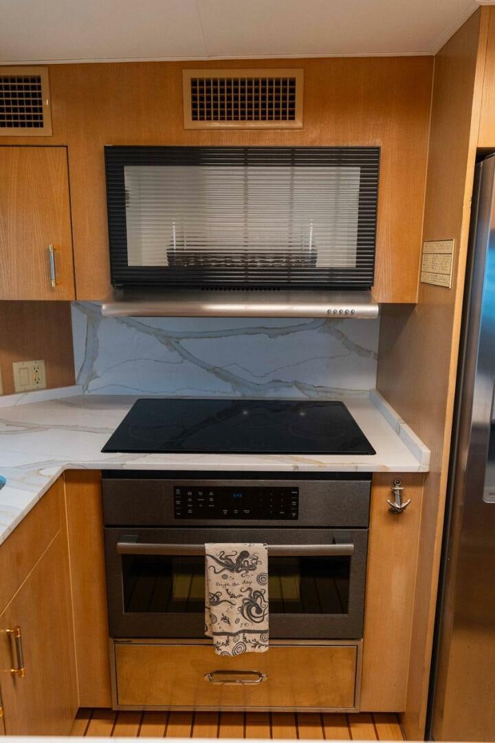 a stove with a vent and a vent in a kitchen aboard KRAKEN Yacht for Sale