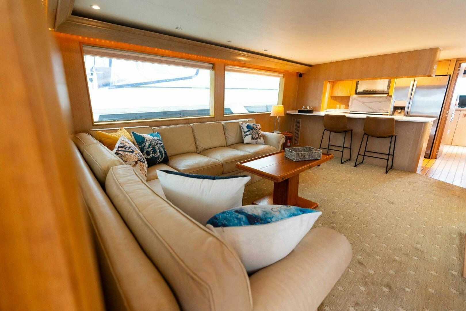 a living room with a couch and a table aboard KRAKEN Yacht for Sale