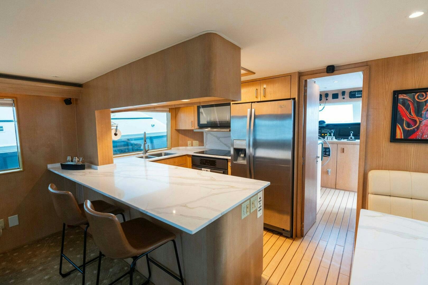 a kitchen with a table and chairs aboard KRAKEN Yacht for Sale
