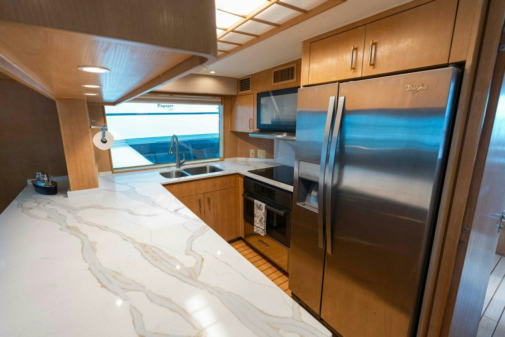 a kitchen with a large refrigerator aboard KRAKEN Yacht for Sale