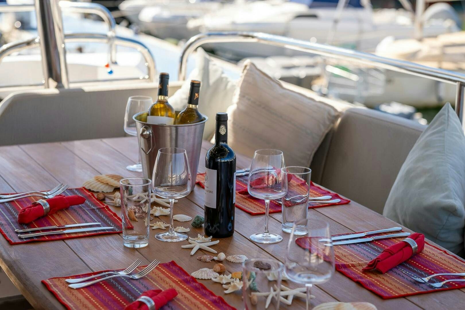a table with wine glasses and bottles aboard INSOMNIA Yacht for Sale