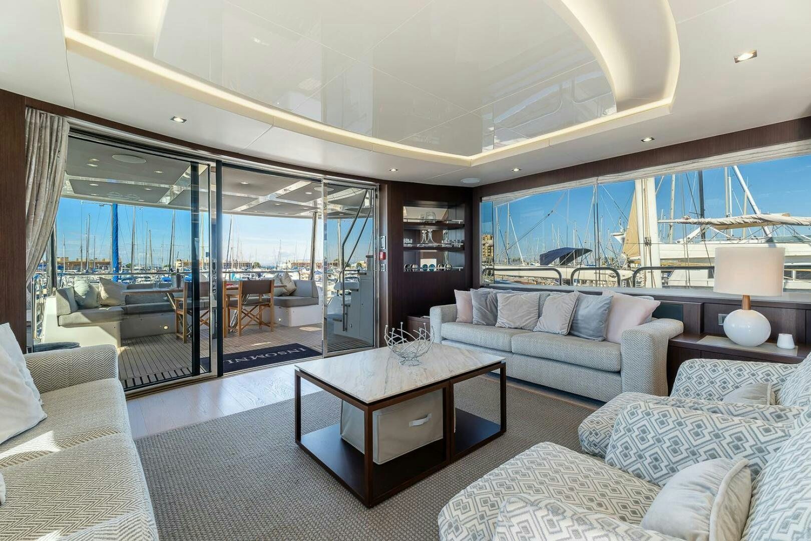 a living room with a large glass window aboard INSOMNIA Yacht for Sale