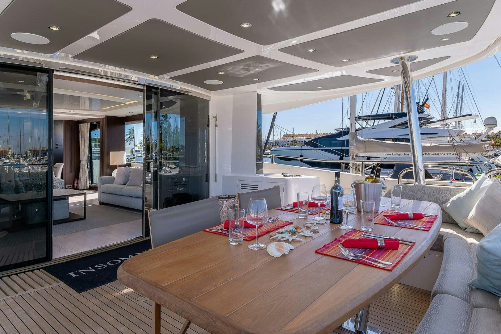 a table with glasses and bottles on it aboard INSOMNIA Yacht for Sale