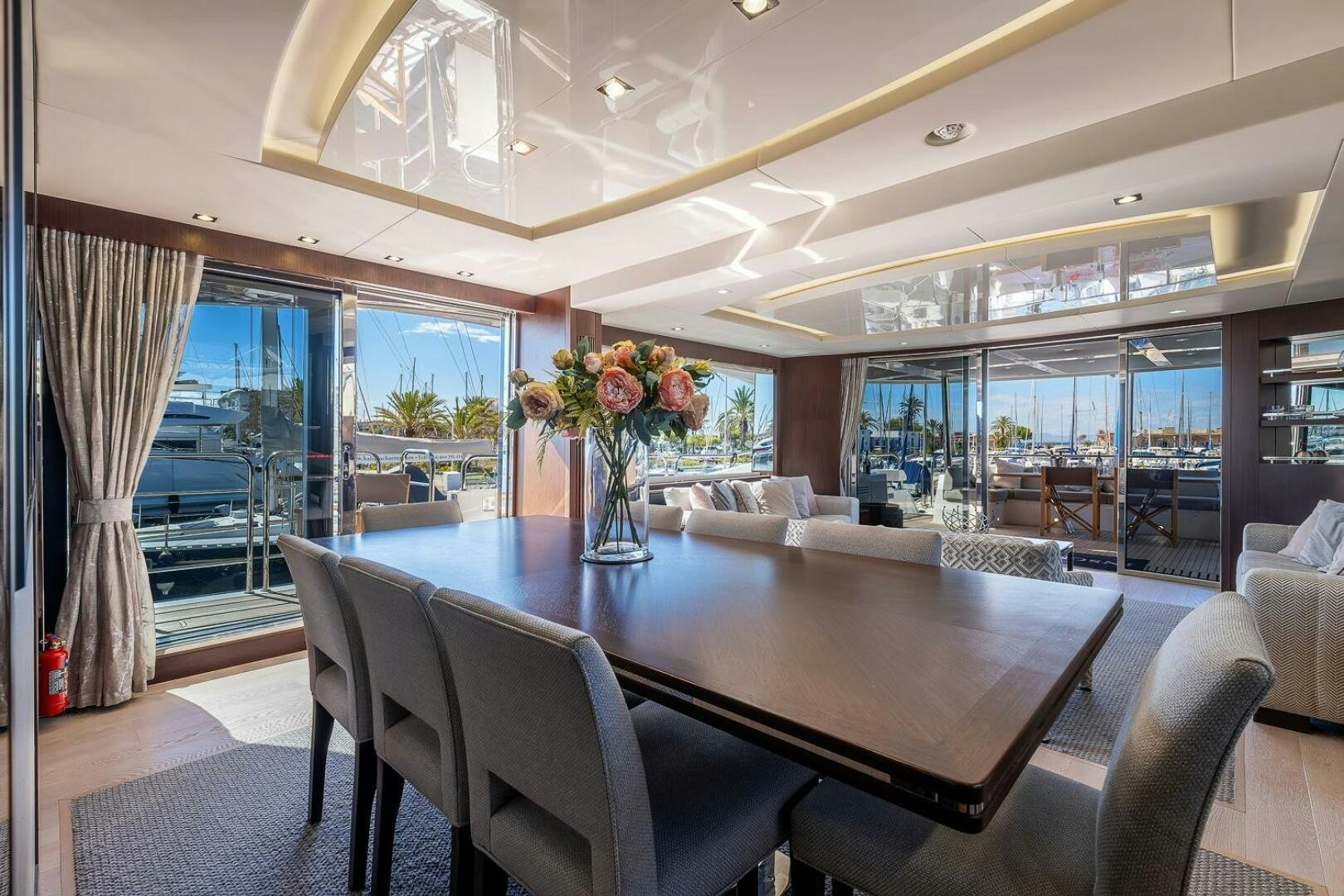 a large room with a table and chairs aboard INSOMNIA Yacht for Sale