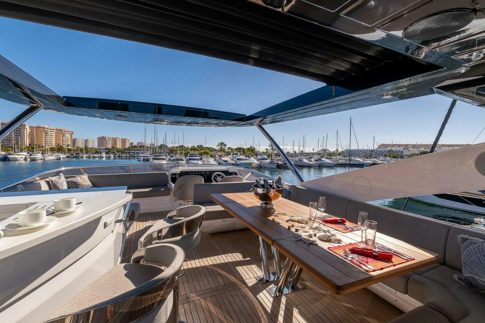 a table on a deck overlooking a city aboard INSOMNIA Yacht for Sale