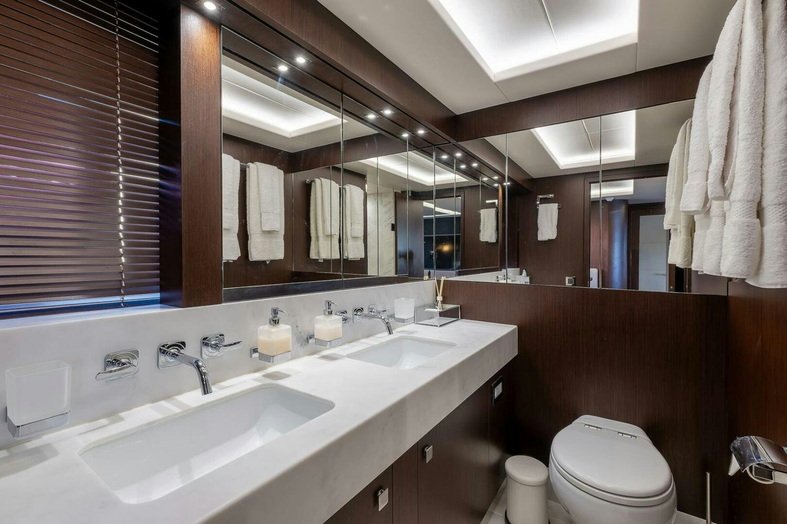 a bathroom with a sink and a toilet aboard INSOMNIA Yacht for Sale