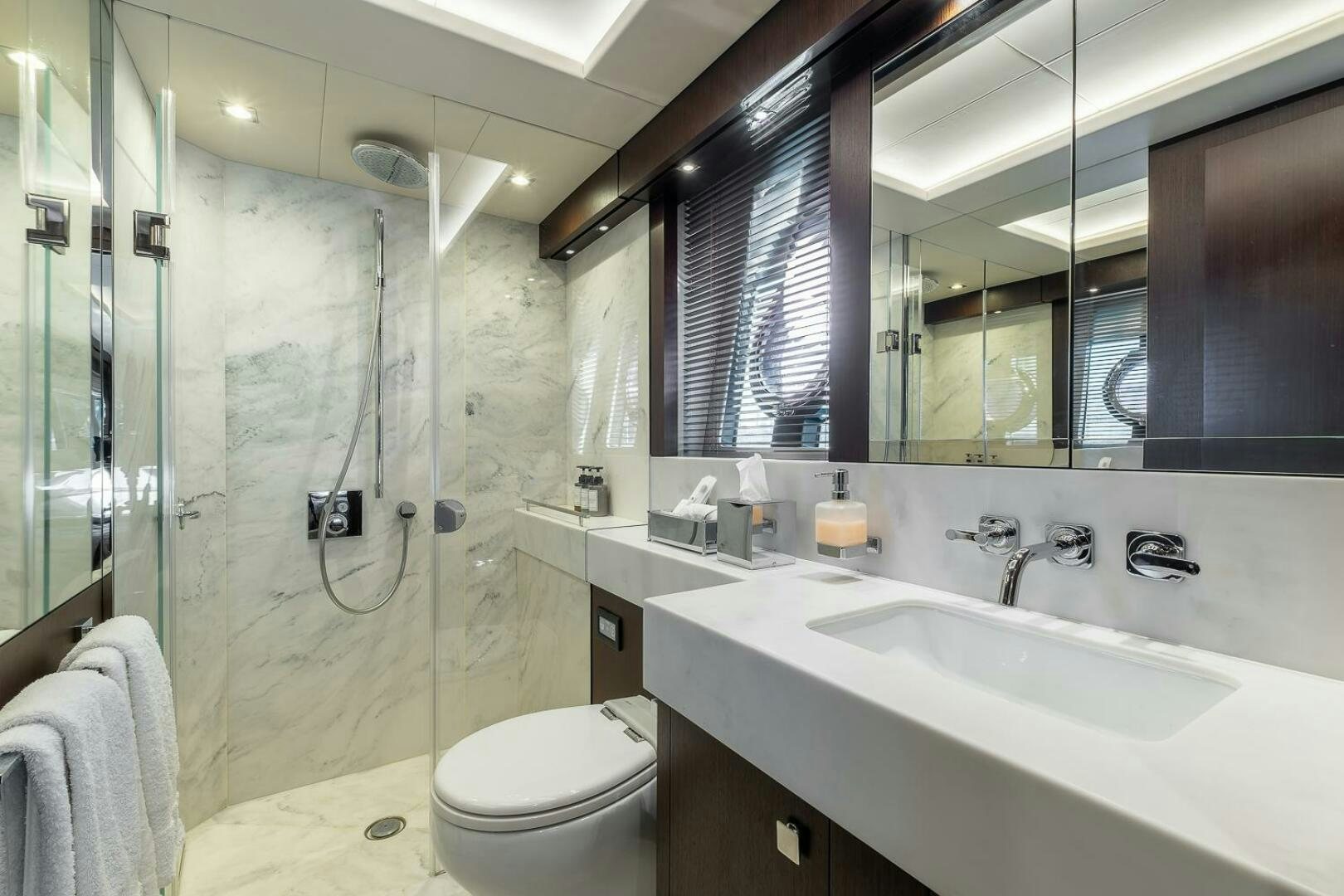 a bathroom with a glass shower aboard INSOMNIA Yacht for Sale