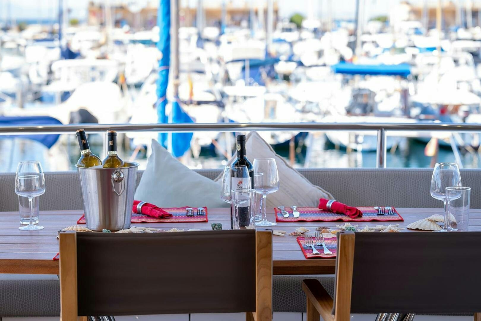 a table with glasses and bottles on it aboard INSOMNIA Yacht for Sale