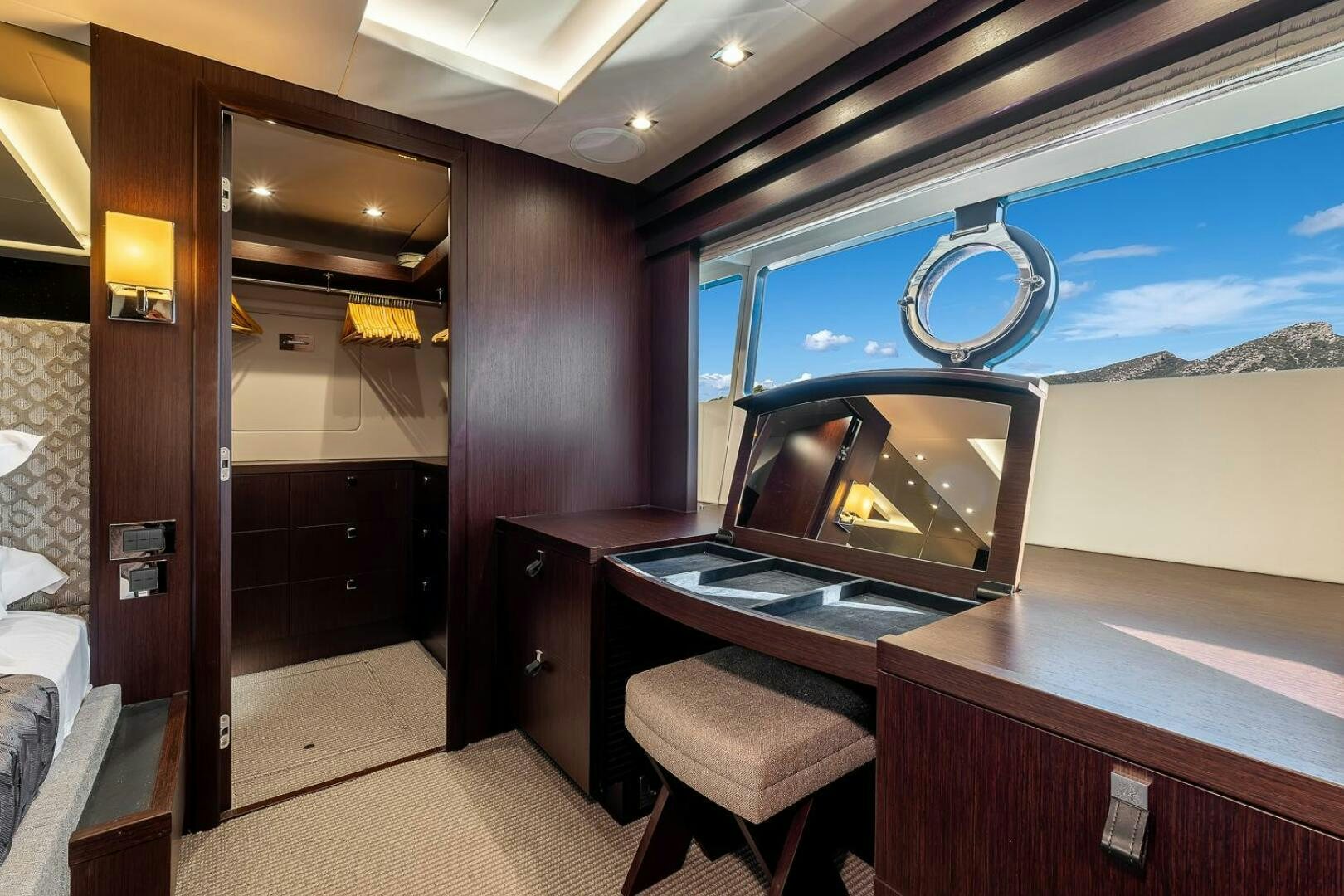 a room with a fireplace and a table with chairs aboard INSOMNIA Yacht for Sale