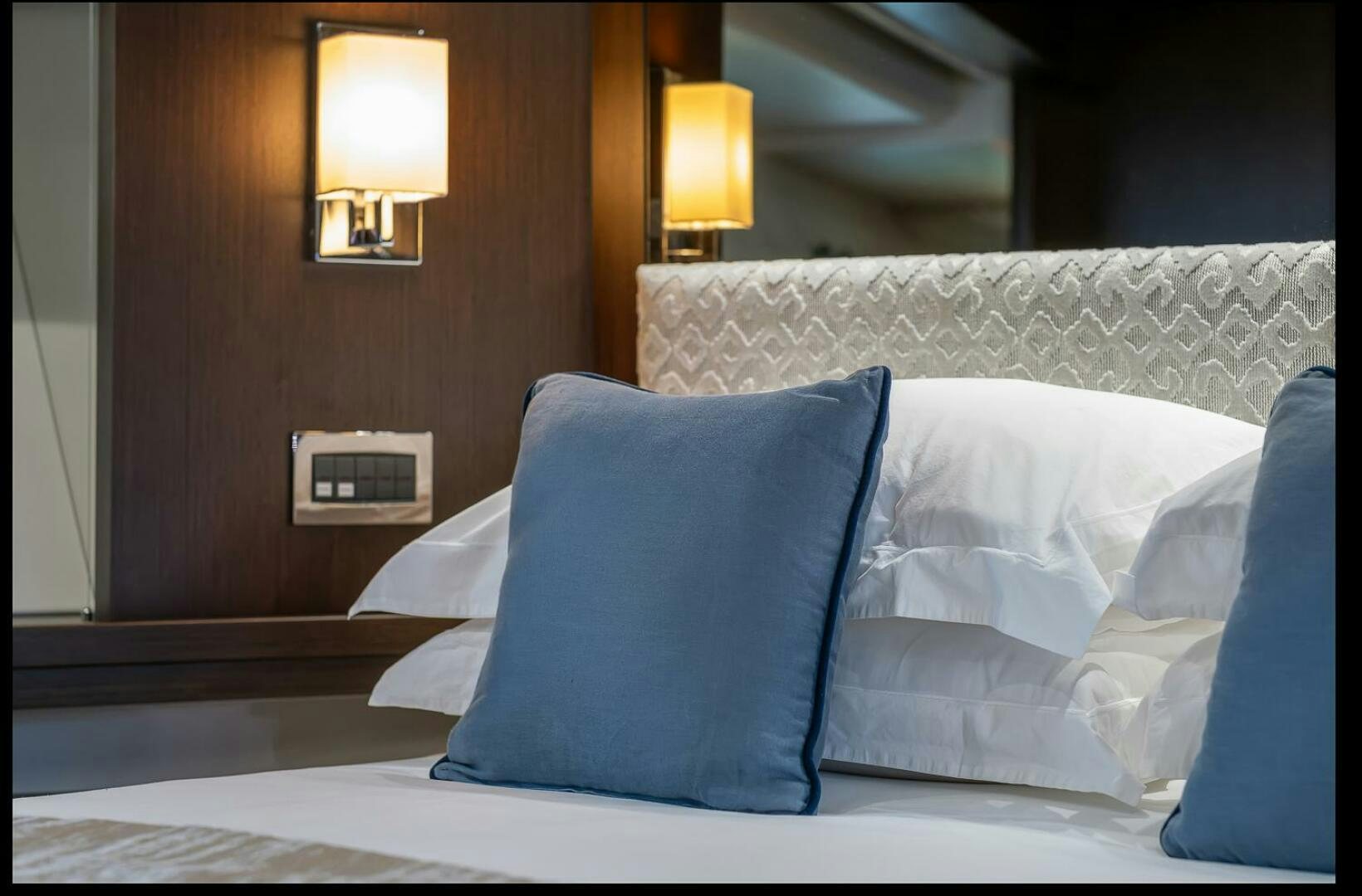 a bed with pillows aboard INSOMNIA Yacht for Sale