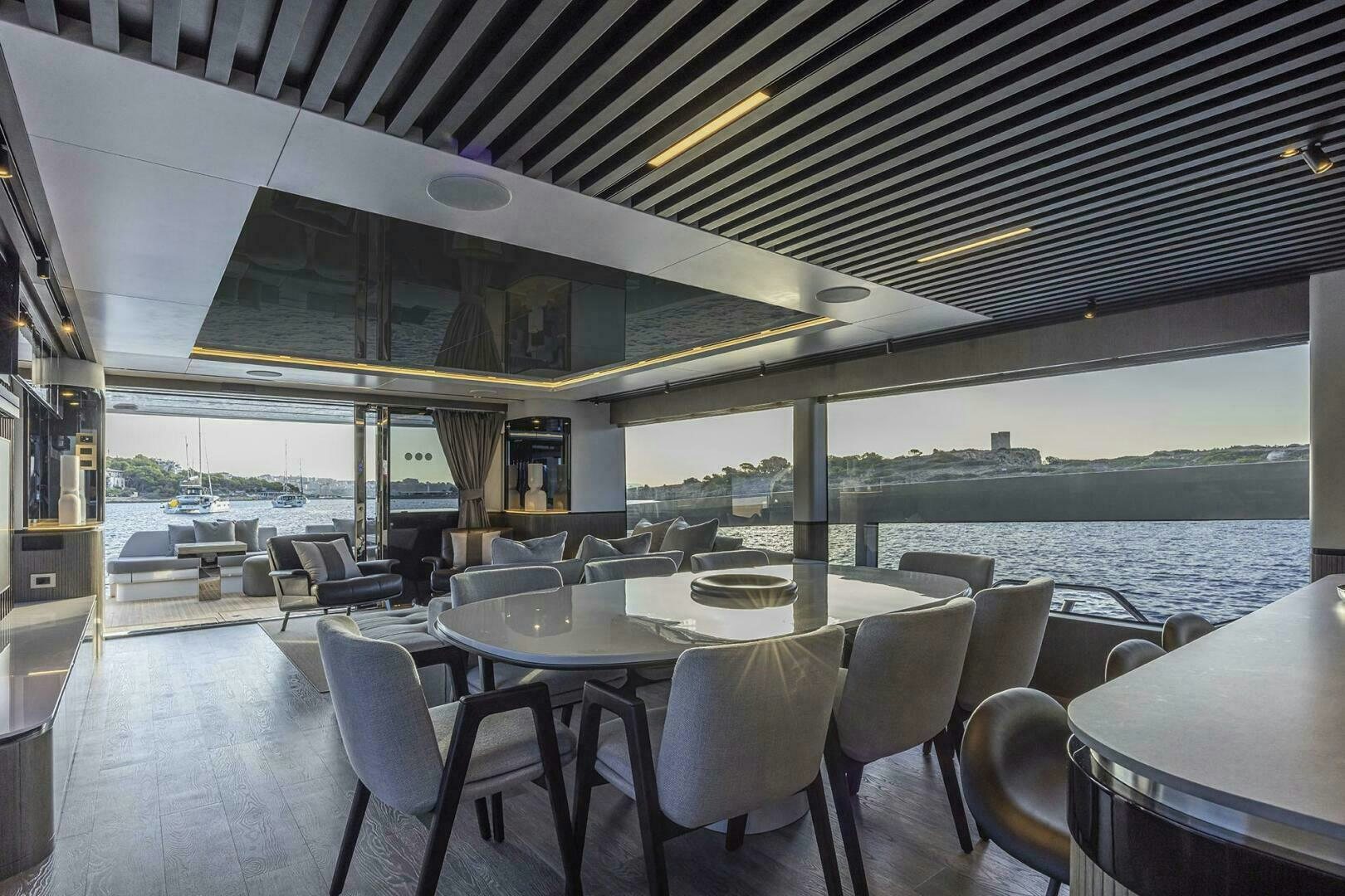 a room with tables and chairs aboard NONE Yacht for Sale