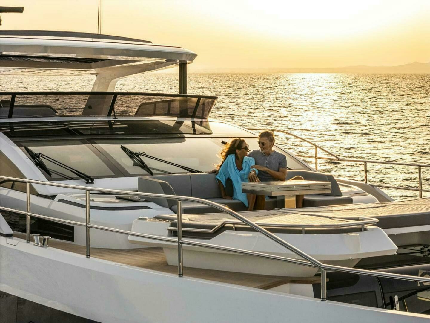 a man and woman sitting on a boat in the water aboard NONE Yacht for Sale