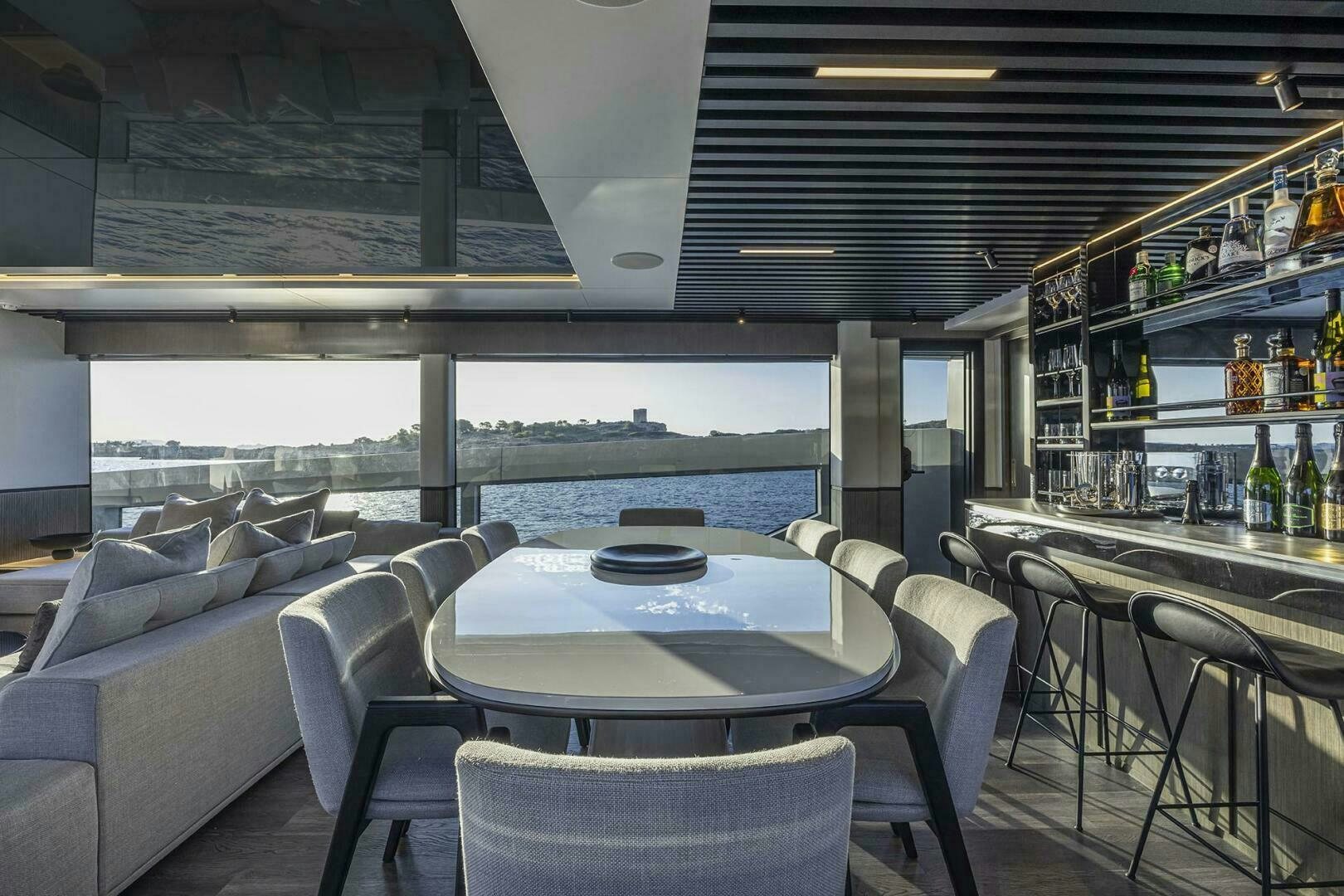 a room with a table and chairs aboard NONE Yacht for Sale