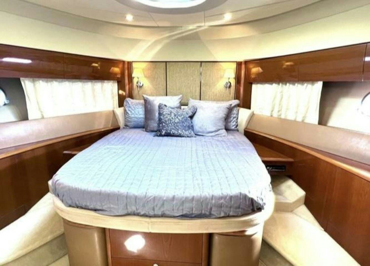 a bed with a blue sheet aboard UNIQ Yacht for Sale