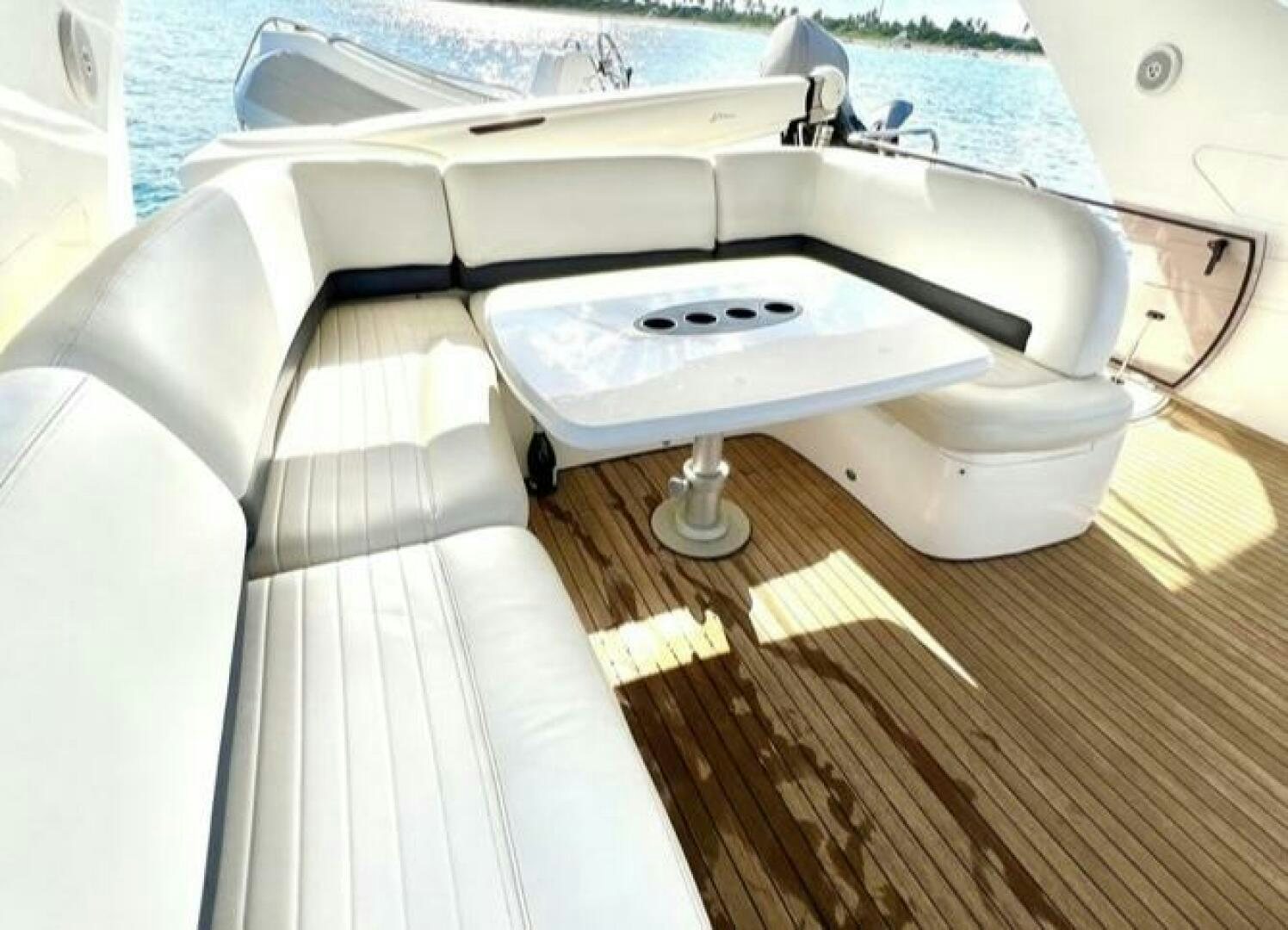 a white boat on a deck aboard UNIQ Yacht for Sale