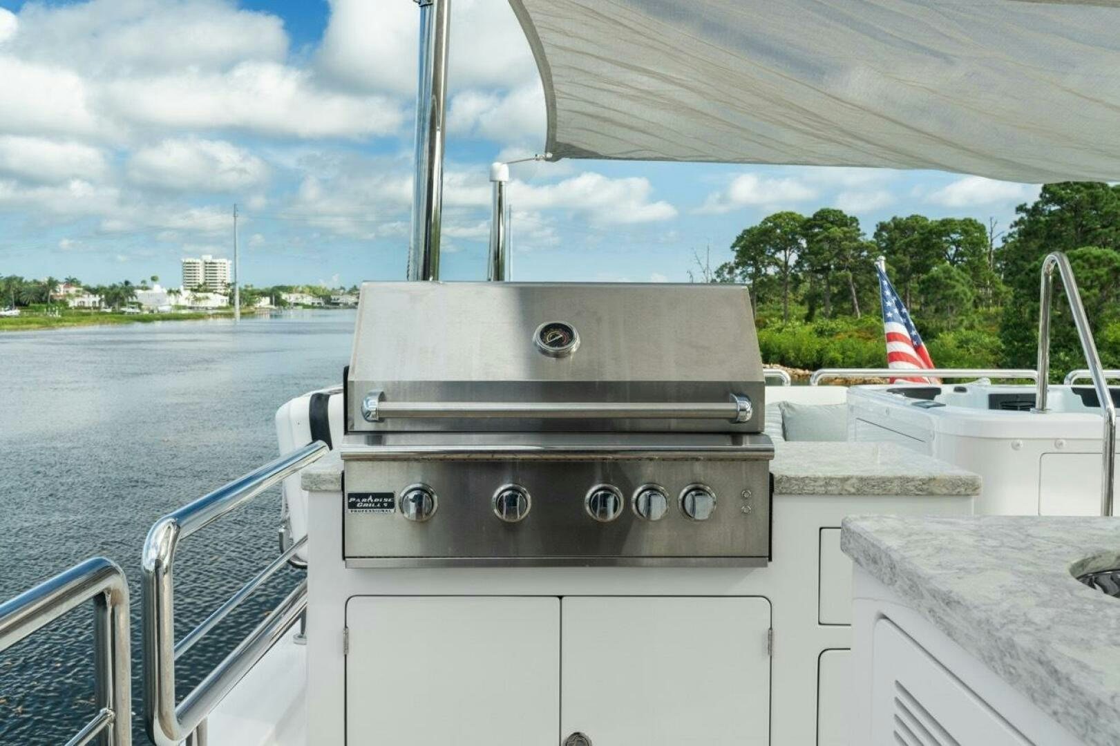 a boat with a flag on the front aboard LADY G Yacht for Sale