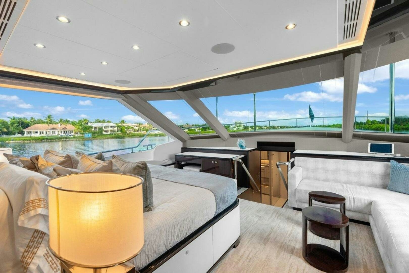 a room with a bed and a view of the city aboard LADY G Yacht for Sale