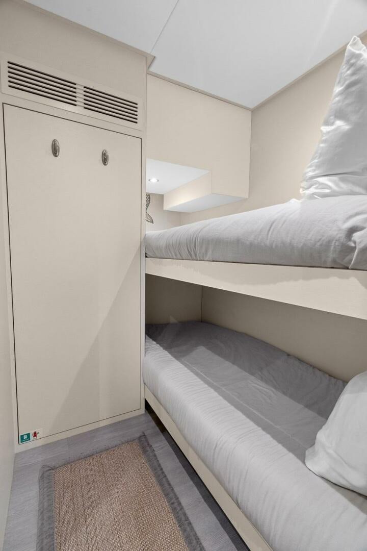 a small room with a bed and a closet aboard LADY G Yacht for Sale