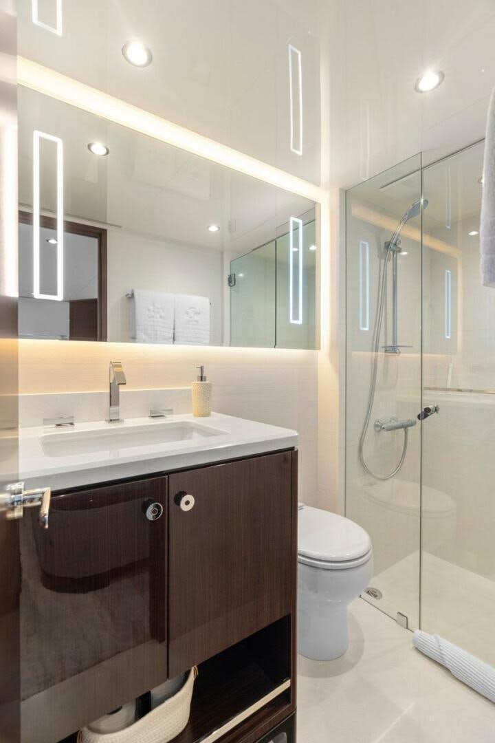 a bathroom with a glass shower aboard LADY G Yacht for Sale